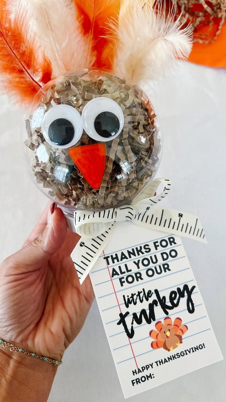 7 Thanksgiving Teacher Gifts for a Heartfelt Thank-You 4 Turkey-themed ornament gift with a thank you tag and orange feathers