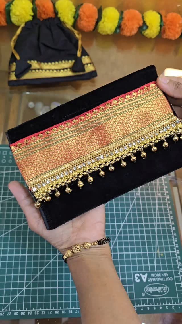 15 Unusual Sewing Gifts to Make for Friends and Family 13 Black velvet clutch purse with gold patterned fabric and beaded fringe trim.