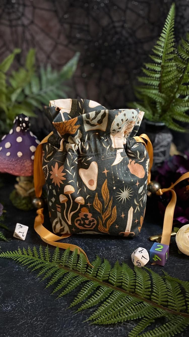 15 Unusual Sewing Gifts to Make for Friends and Family 2 Botanical print drawstring dice bag surrounded by gaming dice and green ferns.
