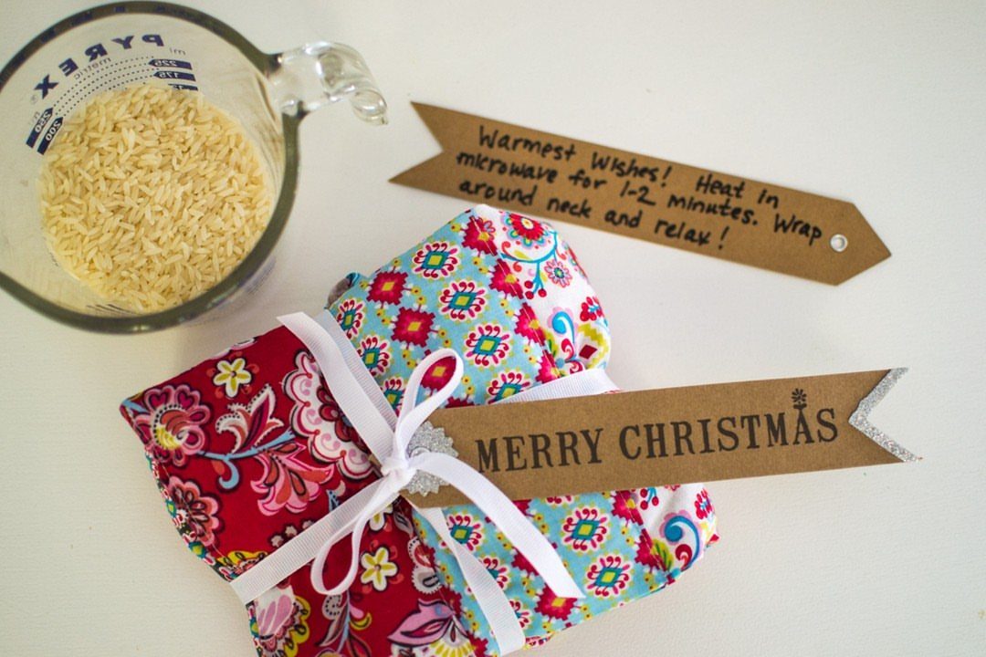 15 Unusual Sewing Gifts to Make for Friends and Family 1 Colorful fabric heating pads with rice in a measuring cup and gift tags.