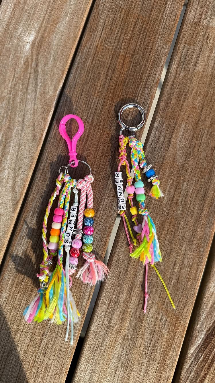 12 Useful Homemade Christmas Gifts People Will Use 11 Two colorful handmade keychains with tassels and beads on a wooden surface.