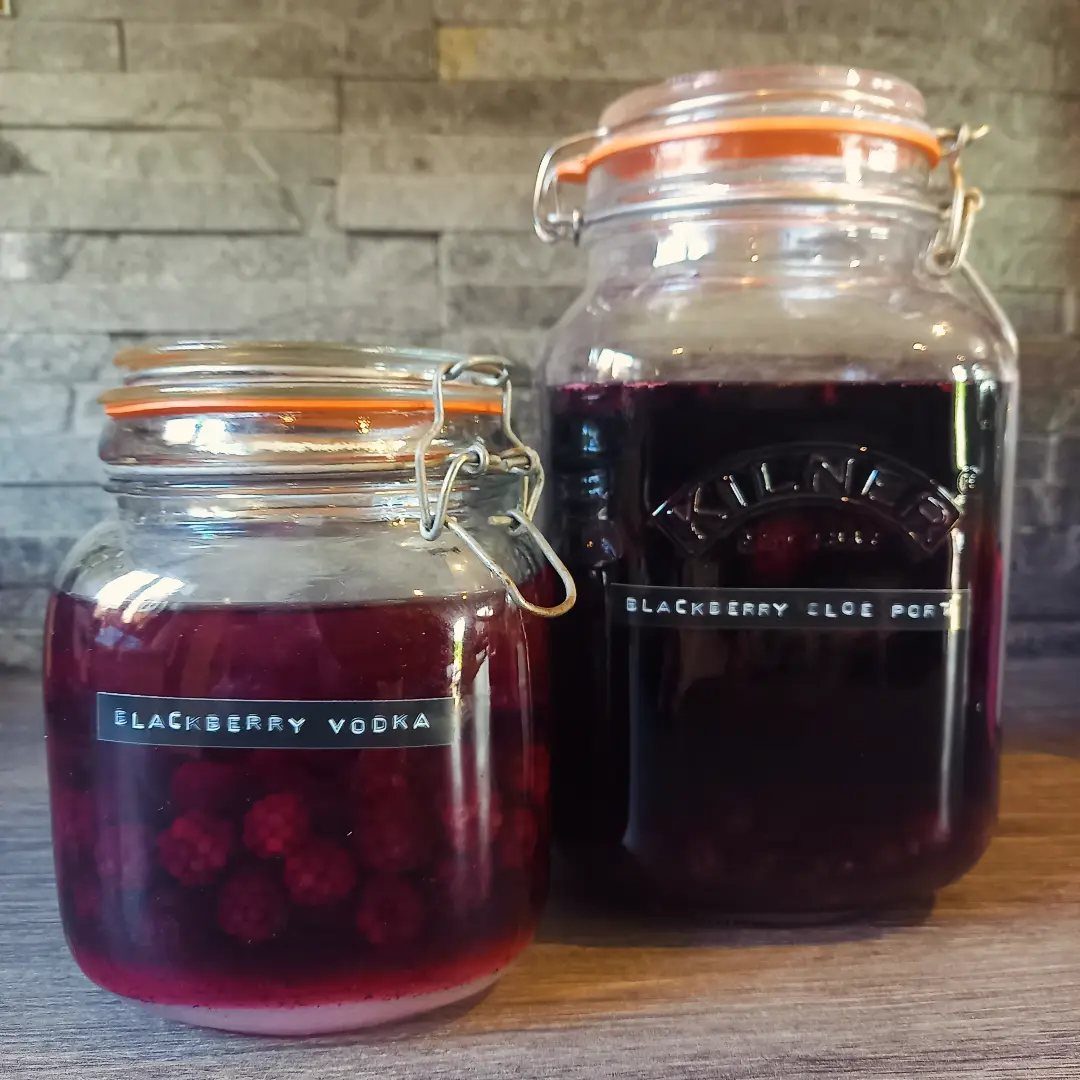 12 Useful Homemade Christmas Gifts People Will Use 6 Two glass jars filled with homemade blackberry vodka and sloe port liqueurs.
