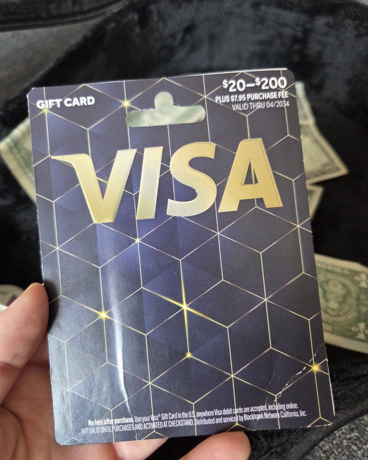 Visa Gift Card Pictures: 5 Card Designs to Browse and Gift 4 Visa gift card held in a hand over US dollar bills
