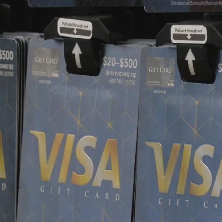Visa Gift Card Pictures: 5 Card Designs to Browse and Gift 1 Blue Visa gift cards with gold text hanging on a retail store display rack