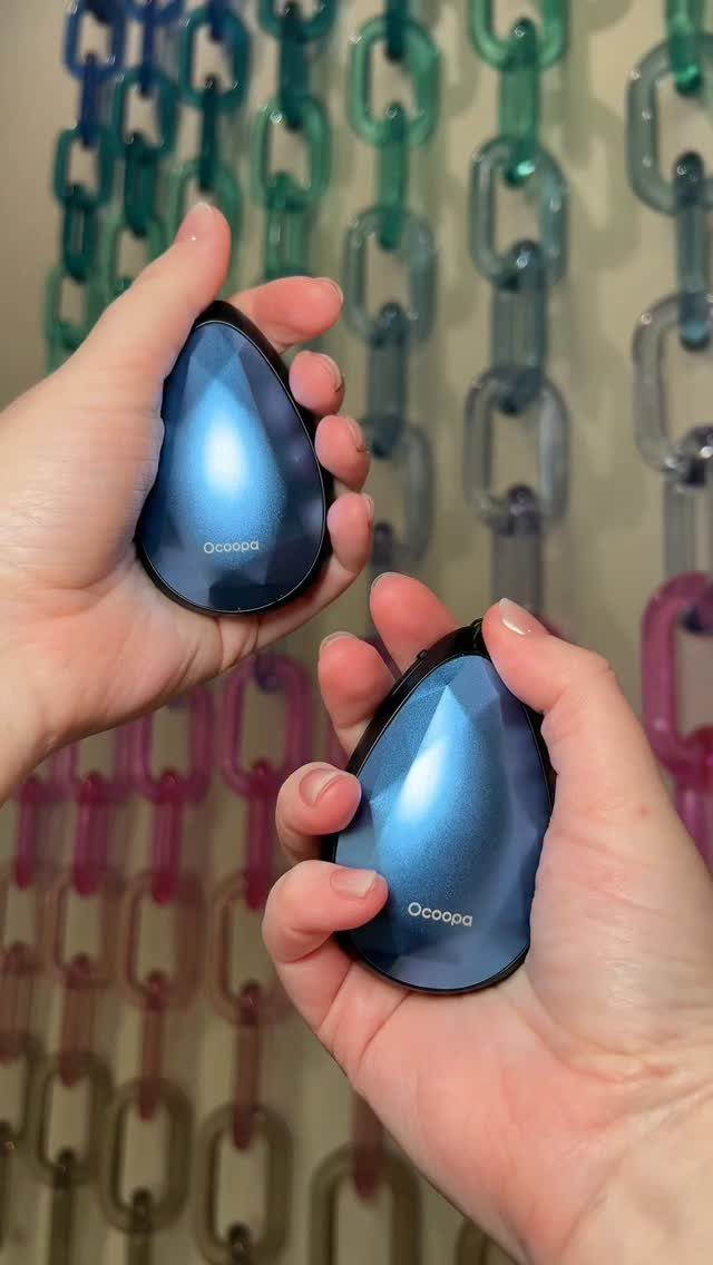 13 Warm and Cozy Gift Ideas for Winter Gifting 12 Two blue electric hand warmers held in hands against colorful plastic chains.