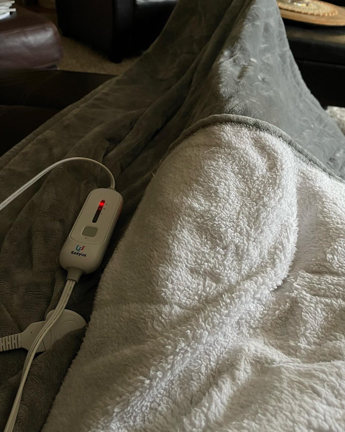 13 Warm and Cozy Gift Ideas for Winter Gifting 3 Grey and white plush electric blanket with a white temperature control remote.