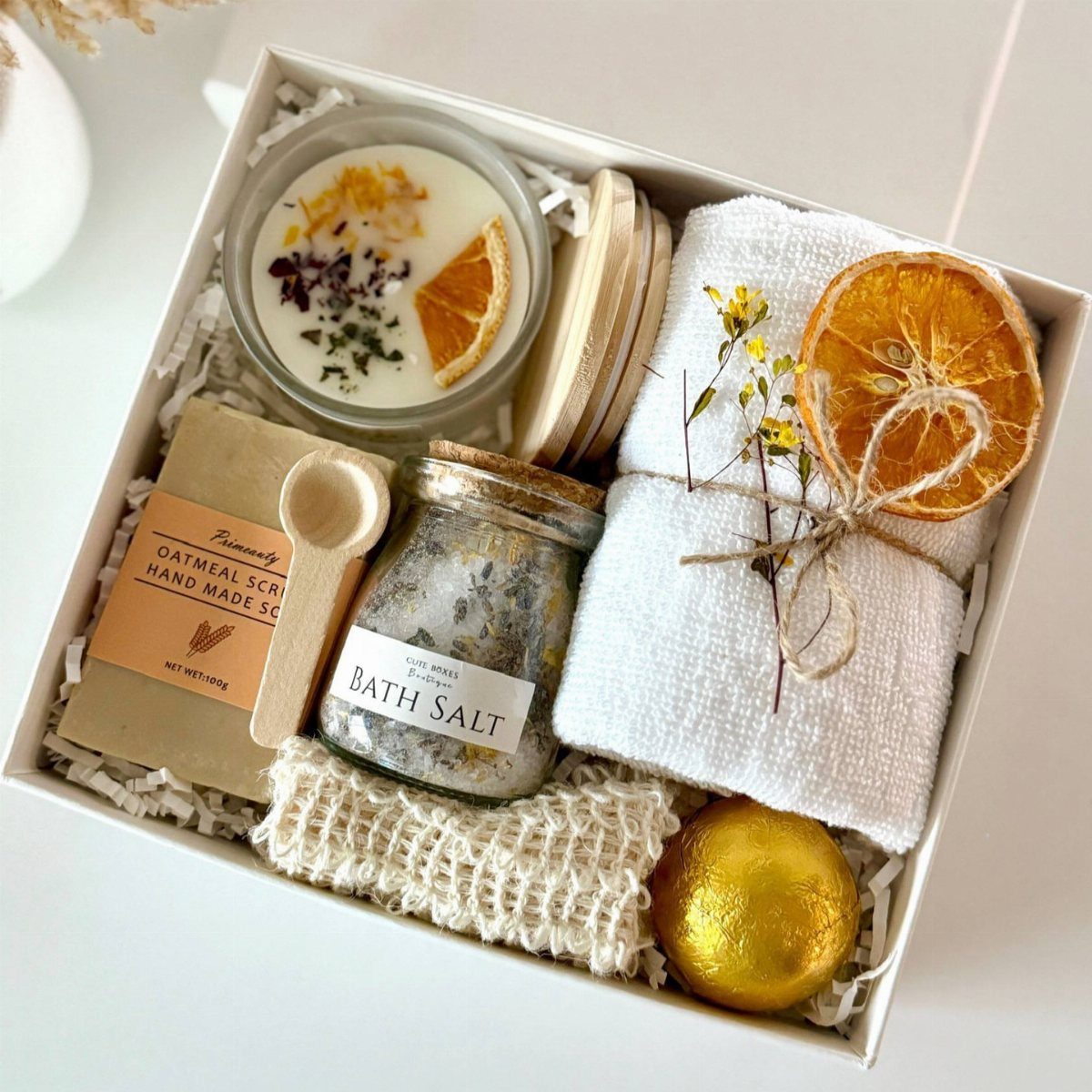 13 Warm and Cozy Gift Ideas for Winter Gifting 13 Luxury bath gift set with candle, bath salts, scrub, towel, and gold bath bomb.