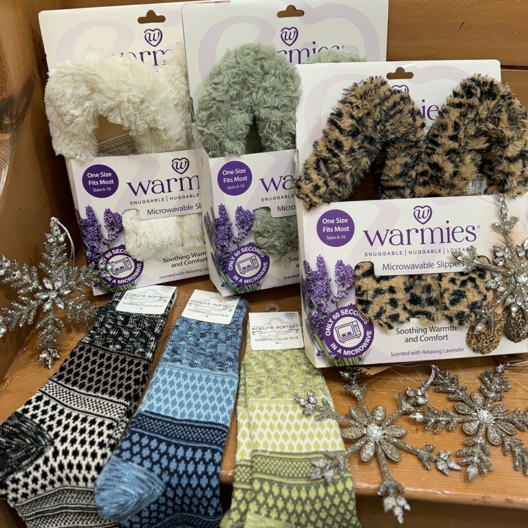 13 Warm and Cozy Gift Ideas for Winter Gifting 6 Microwavable fuzzy slippers in various colors and patterned knit socks with silver snowflakes.