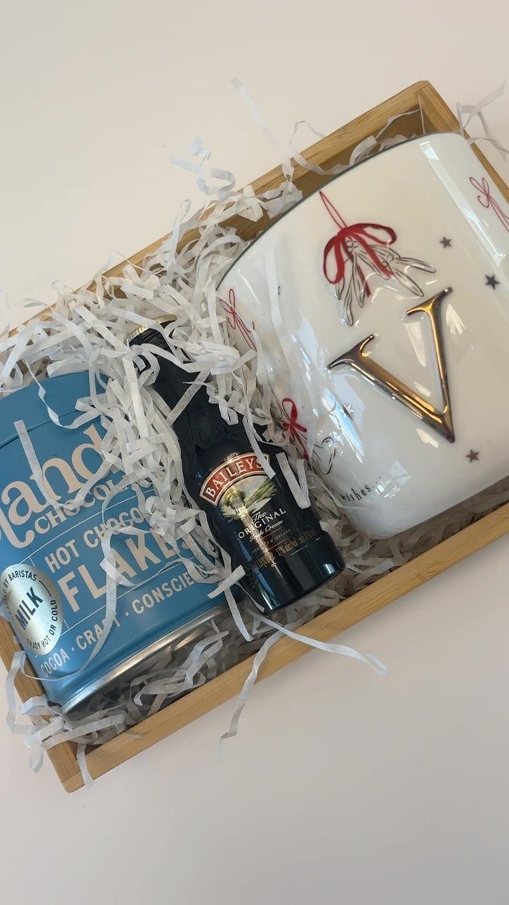 13 Warm and Cozy Gift Ideas for Winter Gifting 9 Wooden gift box containing hot chocolate flakes, syrup, and a personalized white mug.