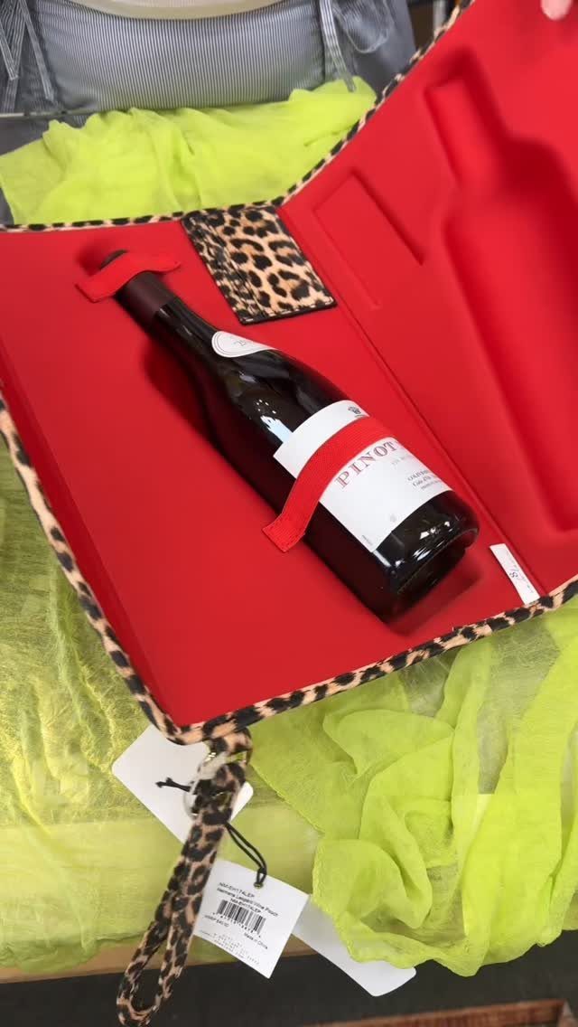 10 Wine Gift Ideas for Every Kind of Wine Lover 7 Leopard-print wine carrier bag with red lining holding a bottle of Pinot Noir.