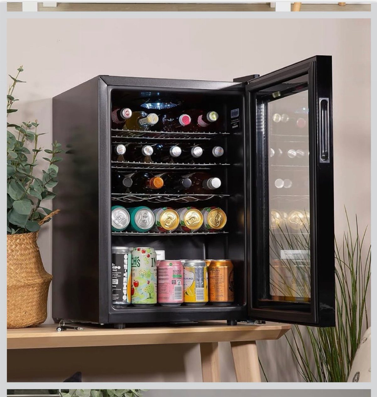 10 Wine Gift Ideas for Every Kind of Wine Lover 8 Black electric wine chiller on a wooden table filled with wine and cans.