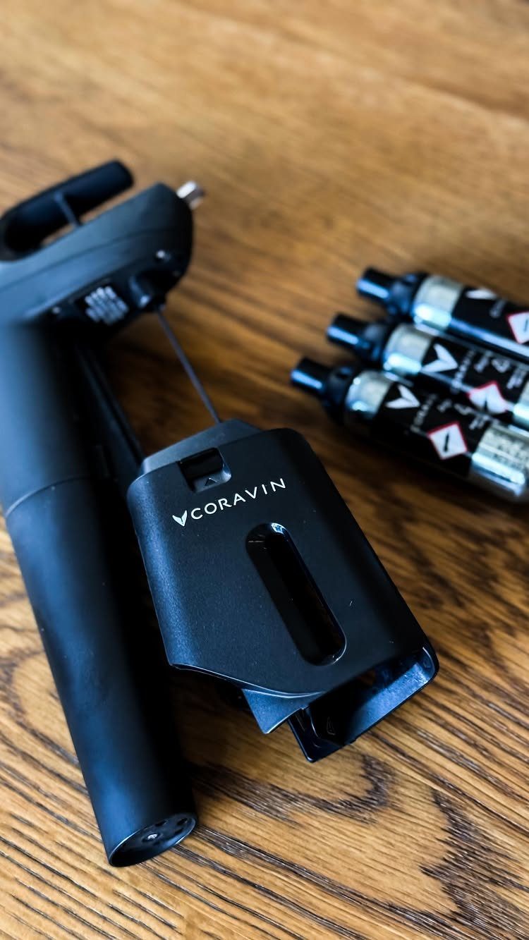 10 Wine Gift Ideas for Every Kind of Wine Lover 6 Coravin wine preservation system and gas capsules on a wooden table